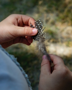 Child holding feather